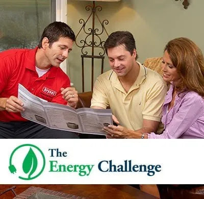 A horizontal banner ad features two men and one woman. In the upper-left, a man in a red collared shirt with a "Bryant" logo on his chest points to an open brochure held by a man and woman. The man and woman, seated side by side on a couch, are looking at the brochure and smiling. The man wears a tan polo shirt, and the woman wears a light purple button-up shirt.