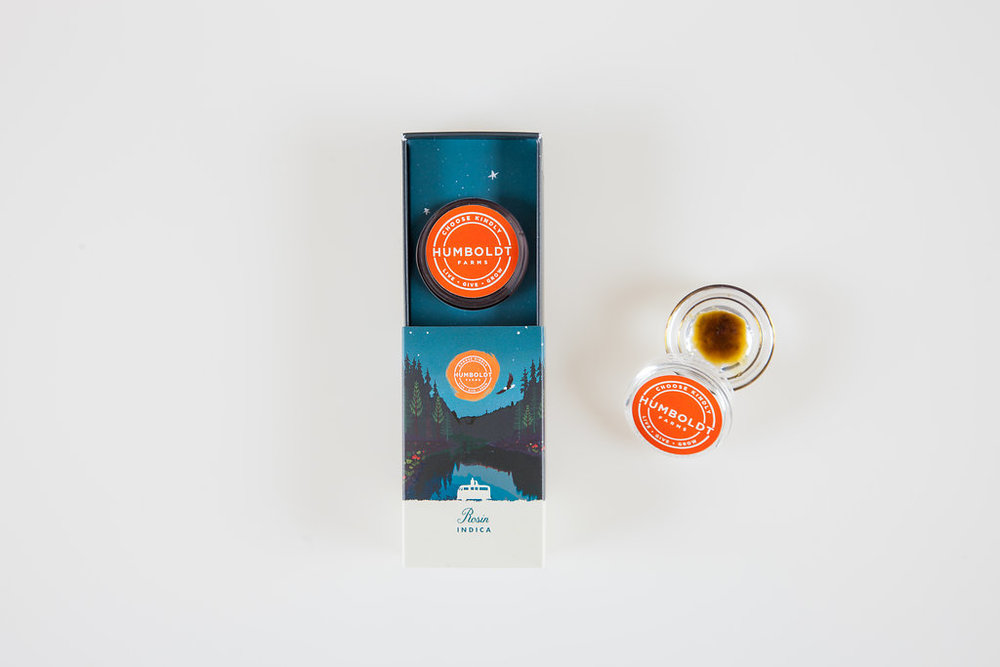 This is an image of Humboldt Farm's packaging for it's resin product, which is sold in a glass dish and placed inside a box with a pullout drawer. This piece of packaging is dark blue, and is the Indica resin product.