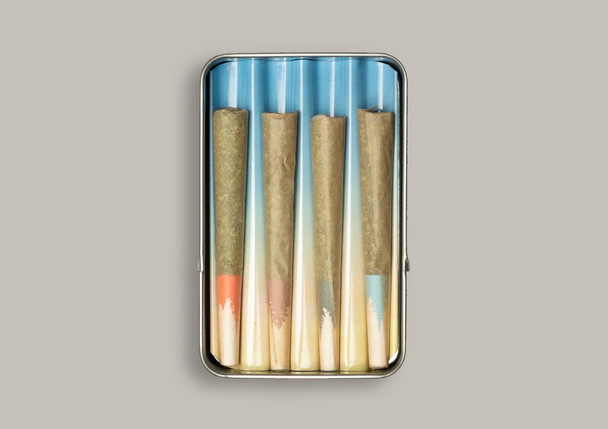 This is a photograph of a case of 4 different pre-rolled joints, shot as a flat lay. It is a variety pack, and there are four different colored filters, indicating a different type of marijuana in each.