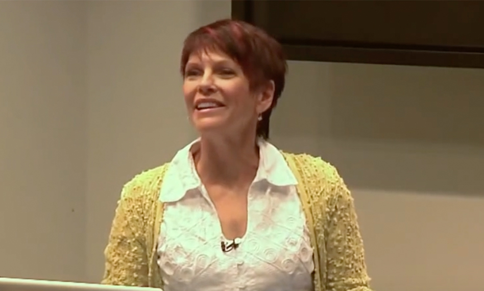 Image of Karen Hutton in a white blouse with a yellow sweater.