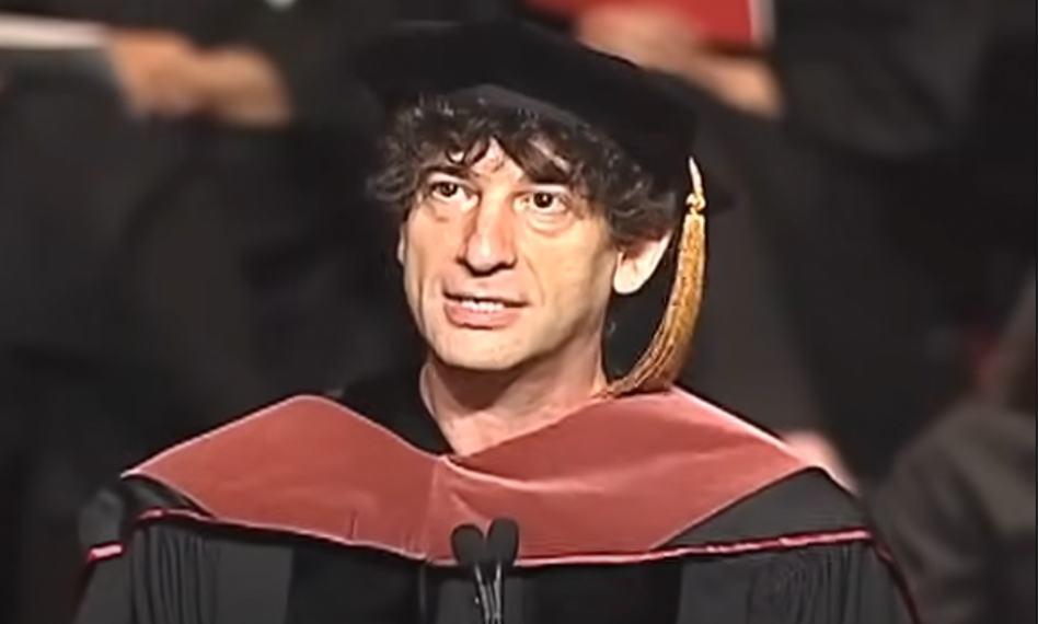 Image of Neil Gaiman in academic robes and a red doctoral hood. 