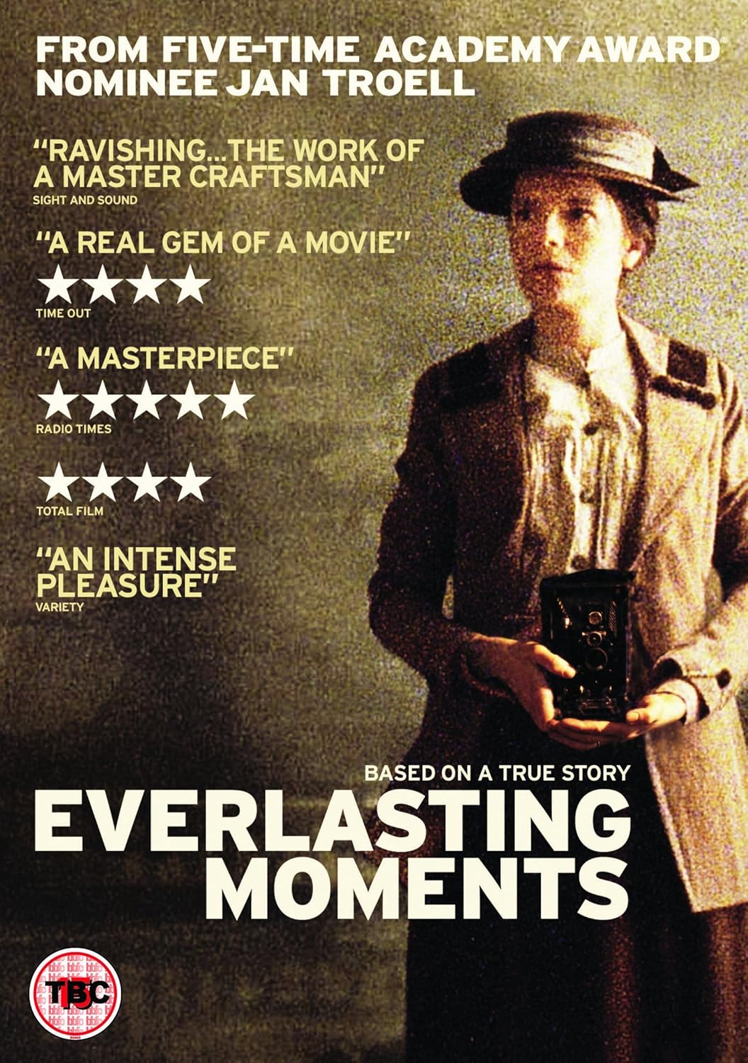 Movie poster for "Everlasting Moments" featuring a grainy photo of a conservatively dressed Victorian woman holding a vintage camera. 