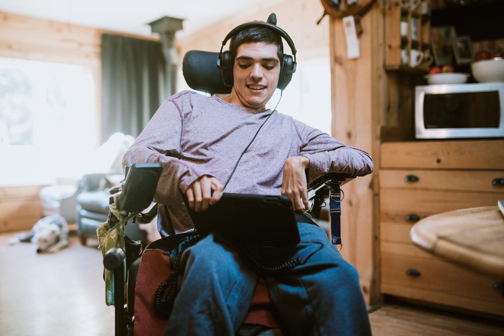 Young person in wheelchair with headphones on