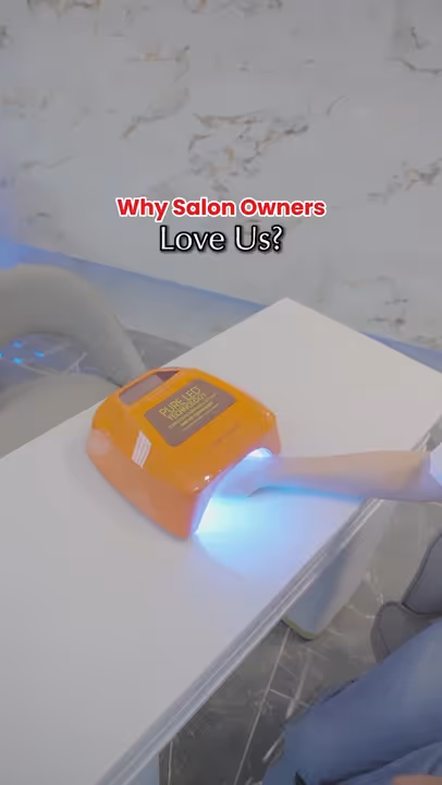 A person using an orange UV nail lamp to cure gel nails on their hand, with text saying 'Why Salon Owners Love Us?'