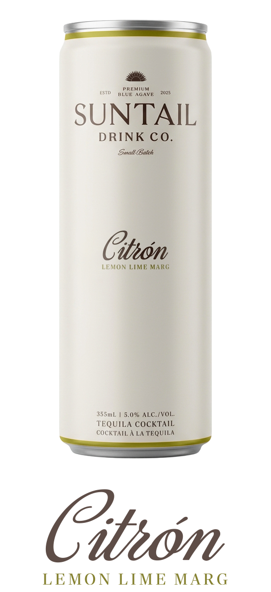 Hand holding metal ice tongs gripping a large round ice sphere against a brown background.