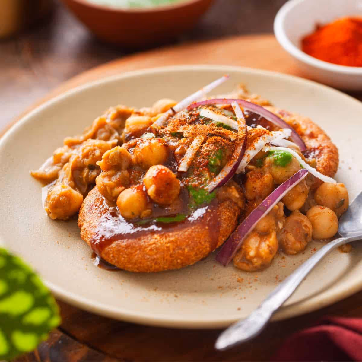 Crispy Indian potato patty flavored with spices and topped with yogurt and chutneys.