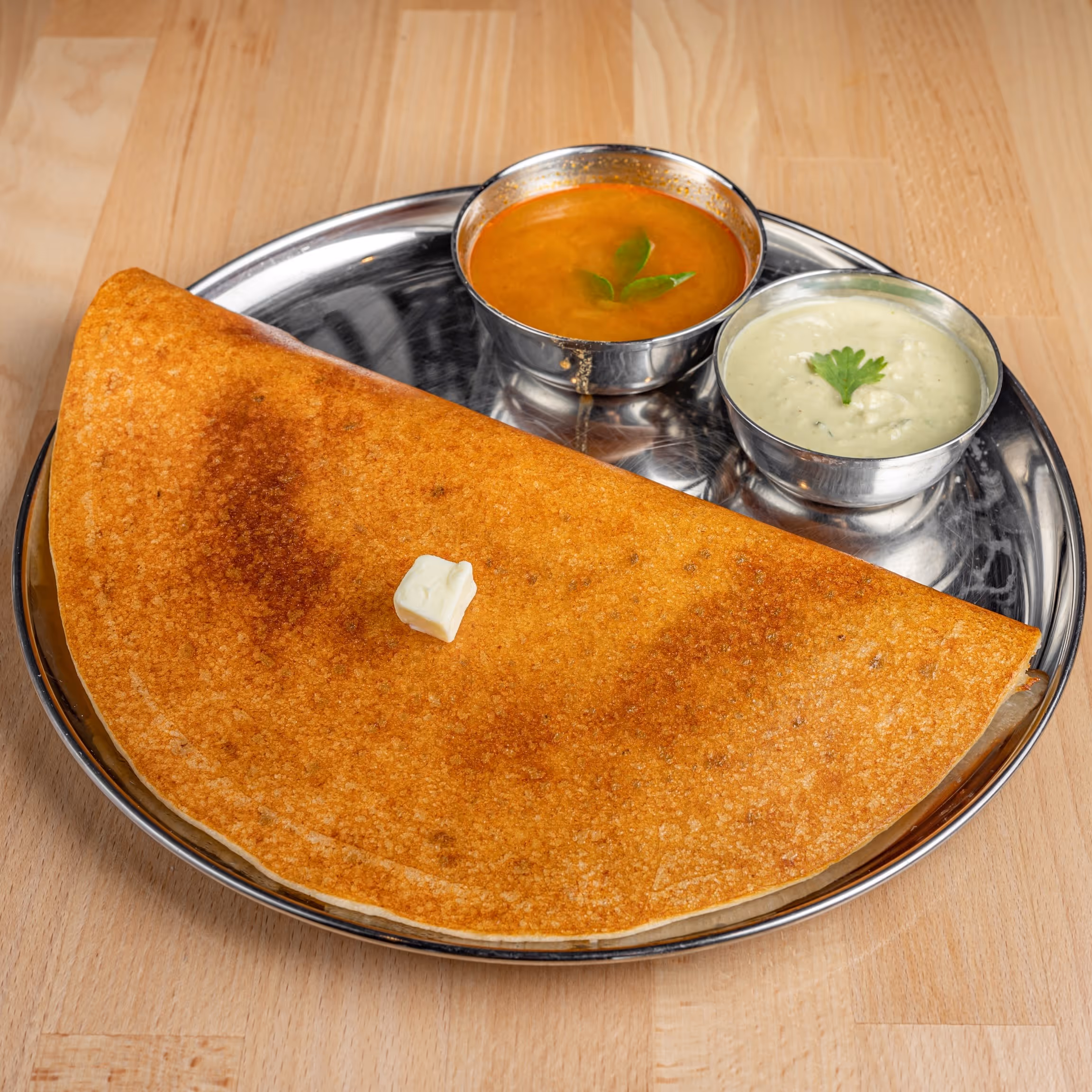 Pancake-type crispy bread made of rice and lentil batter, sprinkled with the choice of ghee and potato masala.