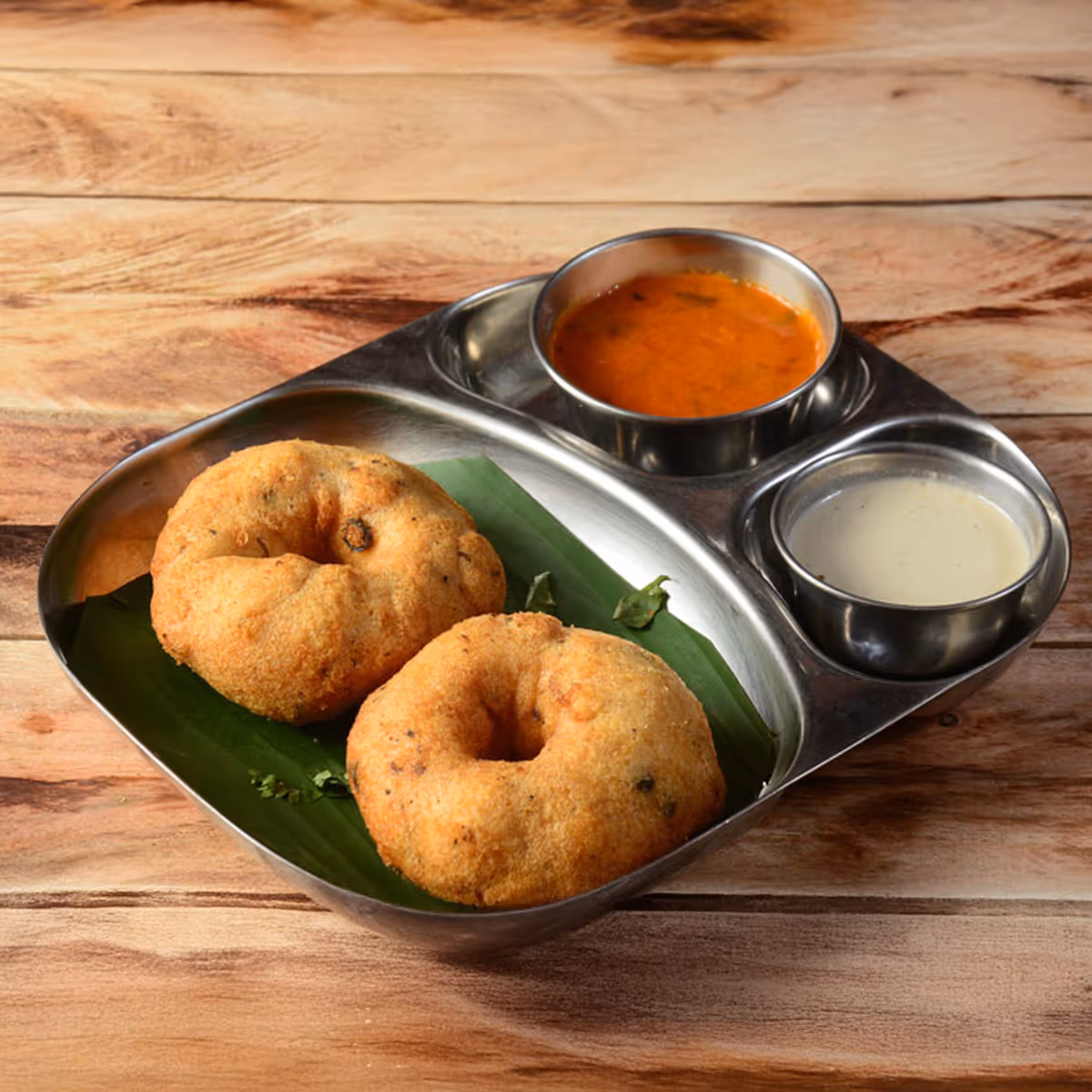 Crispy and soft lentil donut made in traditional style with black pepper & curry leaves, and served with coconut chutney & sambar.