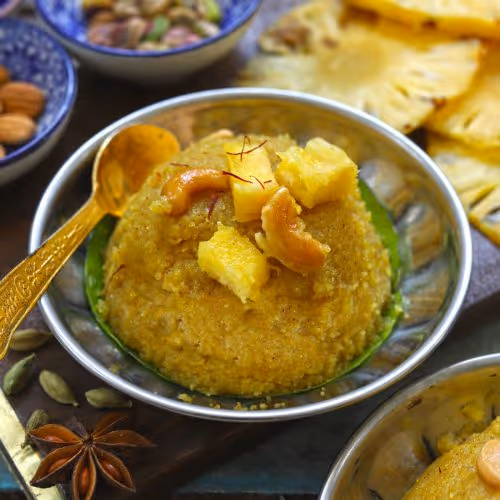 Pineapple Khara Bath is a sweet breakfast dish made with fried rava, crushed pineapple, golden raisins, cashews and ghee.