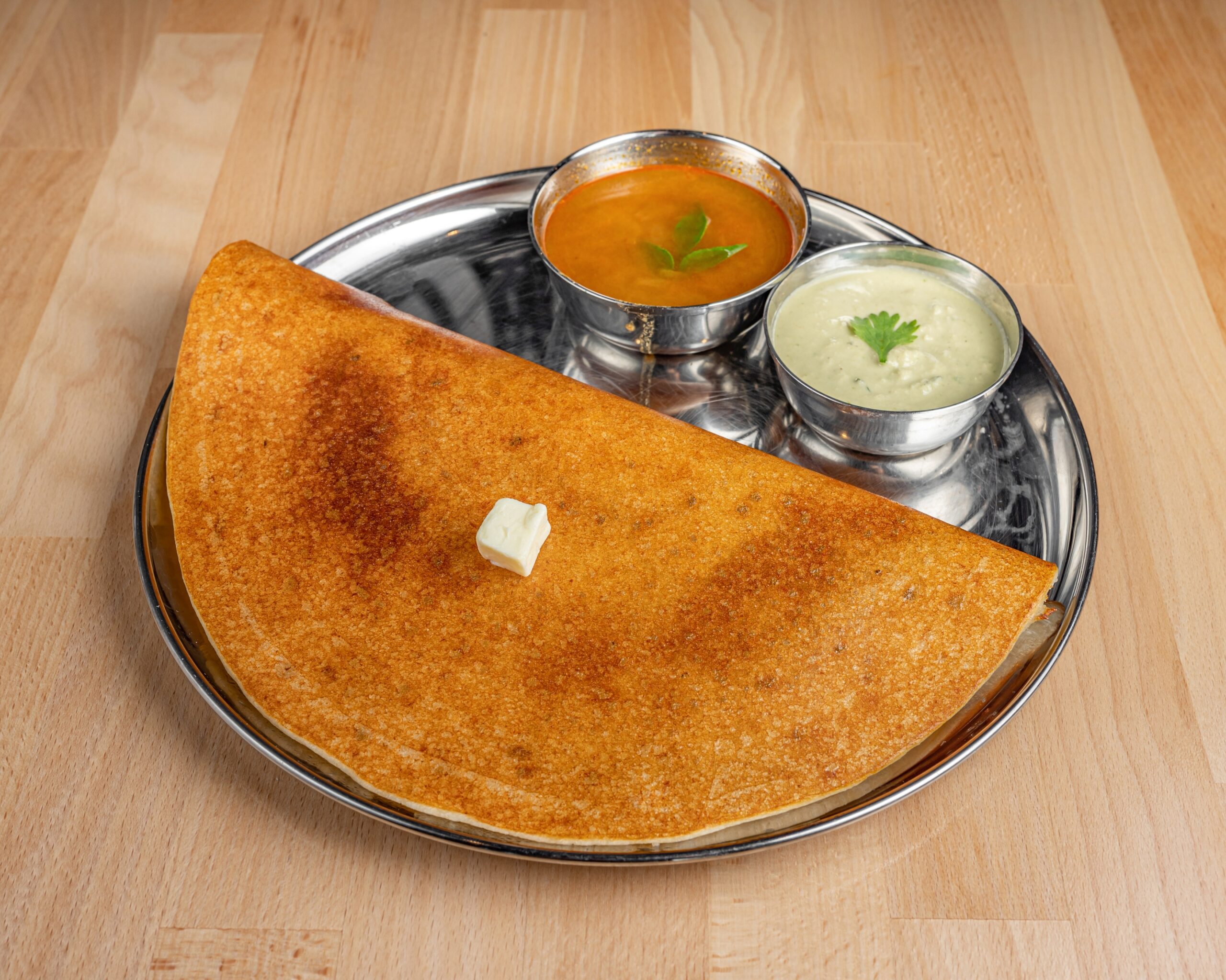 Pancake-type crispy bread made of rice and lentil batter sprinkled with ghee.