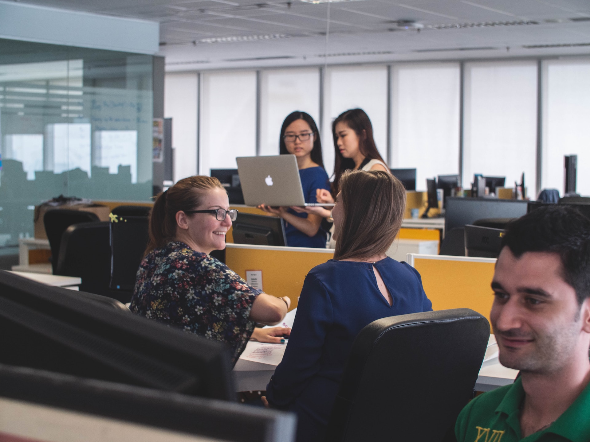 people working together in teams in an office room