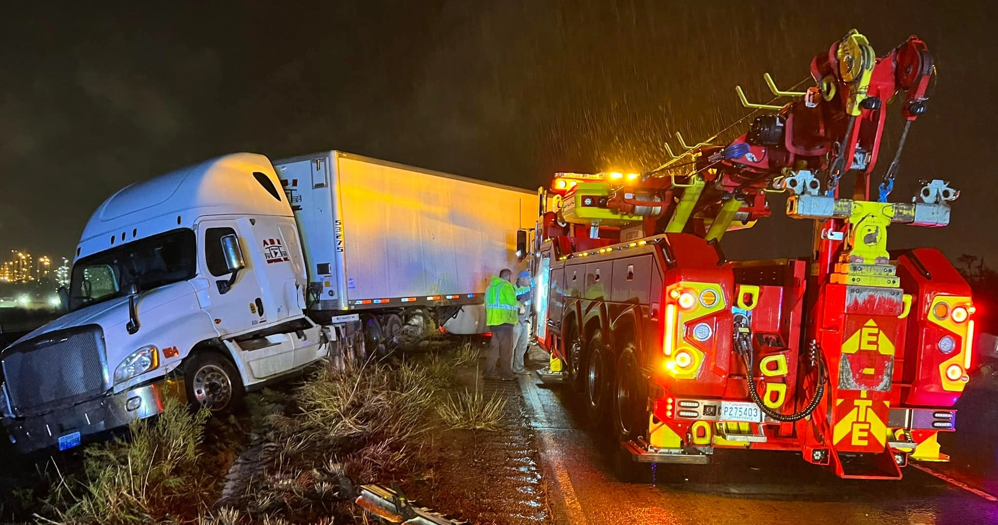 Heavy Rotator Recovering Semi Truck At Night