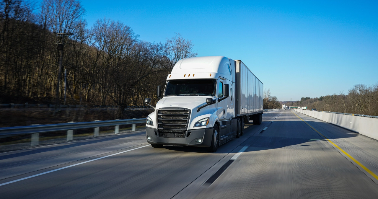 White Semi Truck Traveling Along Open Highway