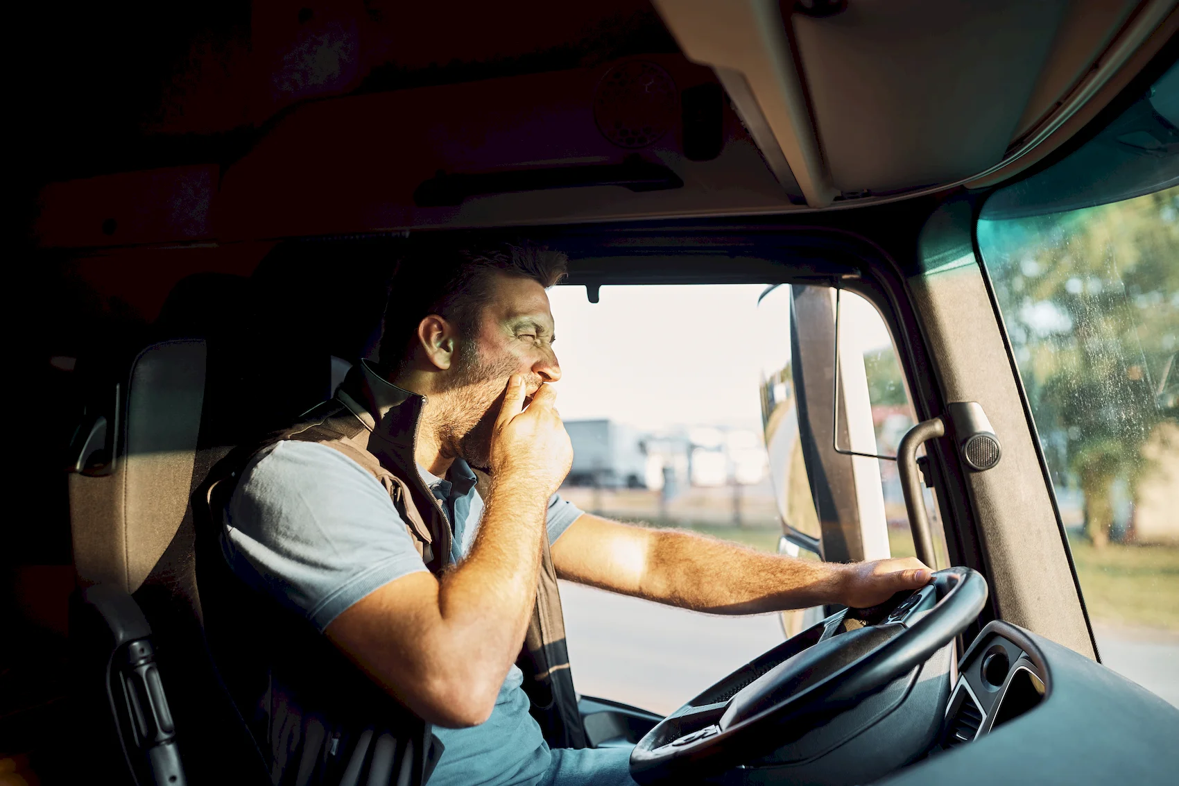Truck Driver Using Phone Behind Steering Wheel