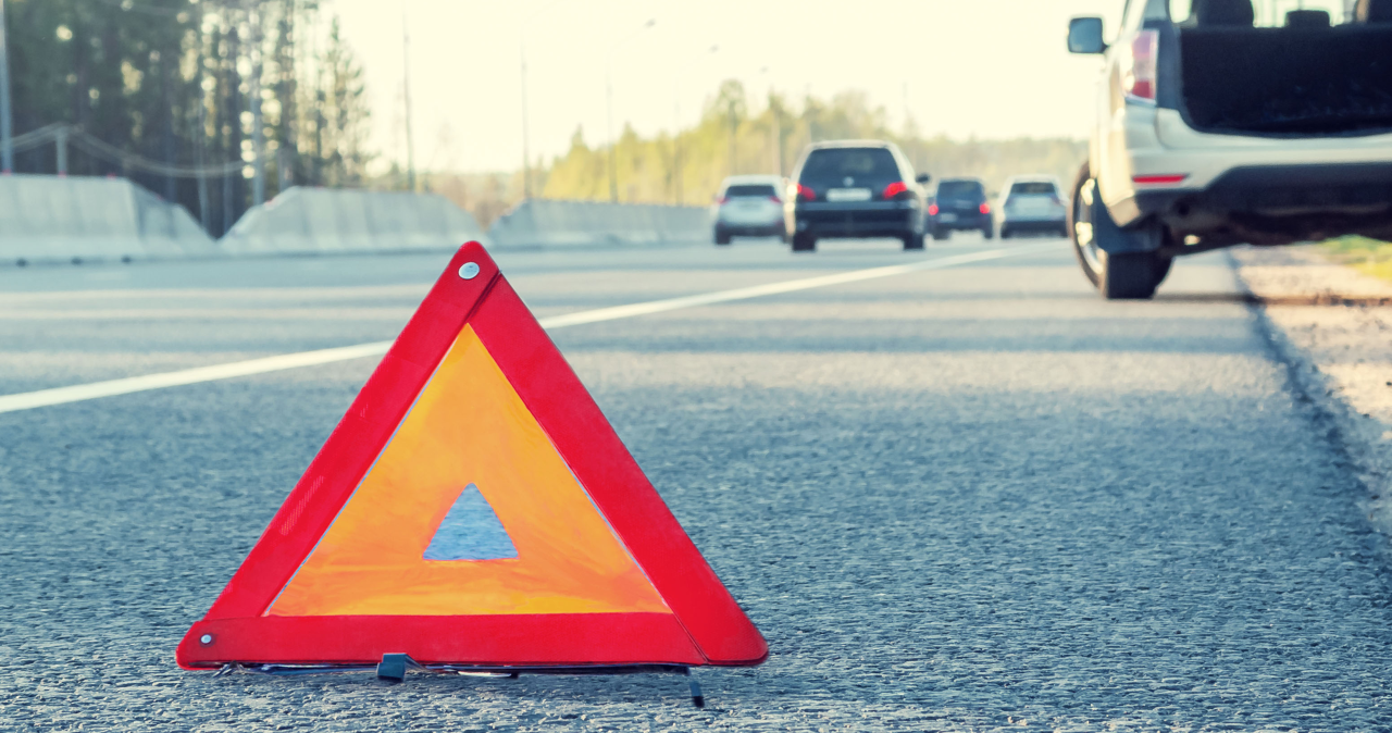 Roadside Warning Triangle Beside Highway Traffic