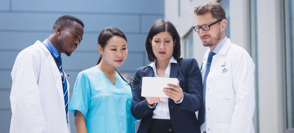 A group of doctors looking at a tablet