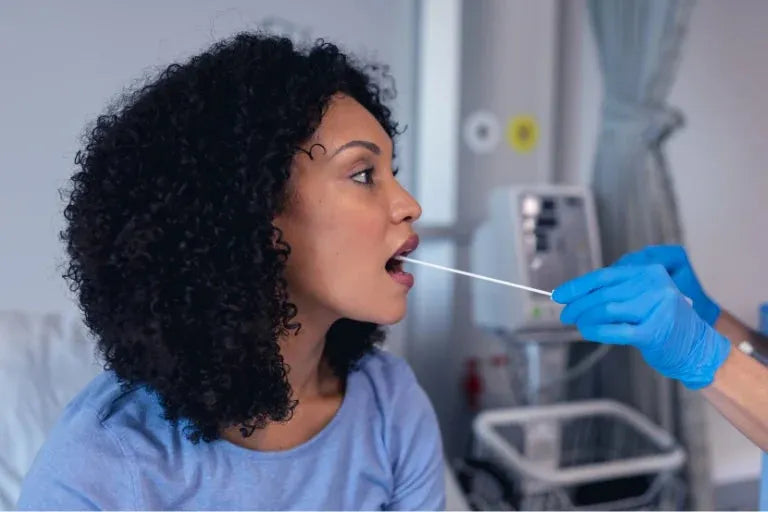 A woman in a blue shirt and blue gloves