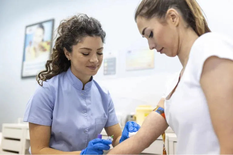 Two women in scrubs are looking at something