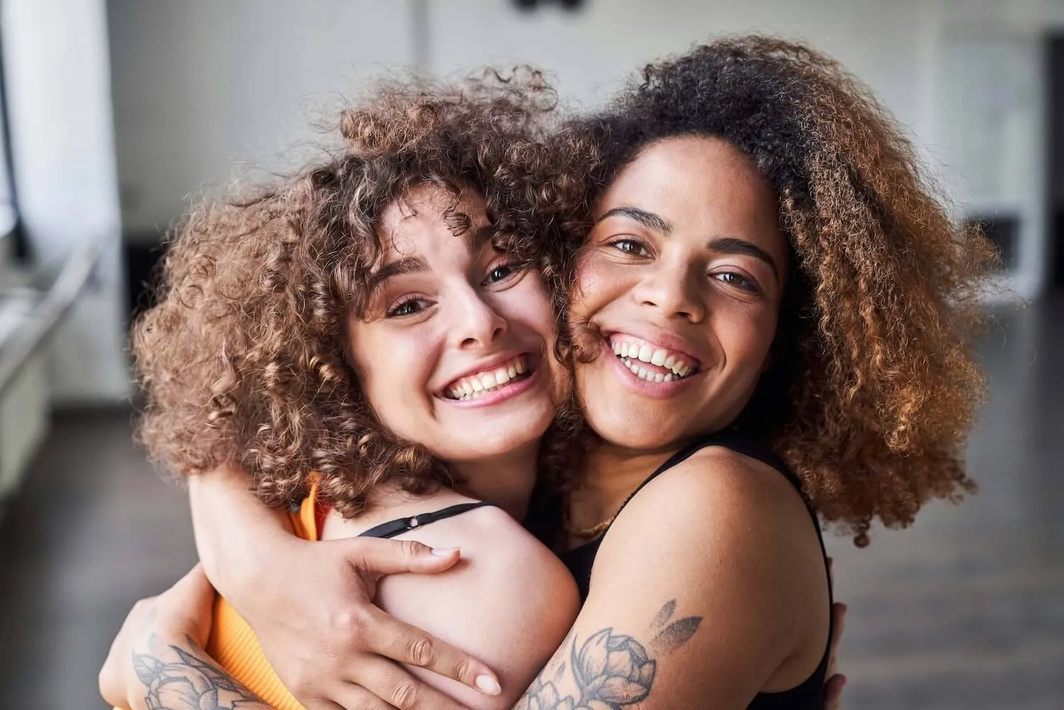 close up of two women hugging and smiling