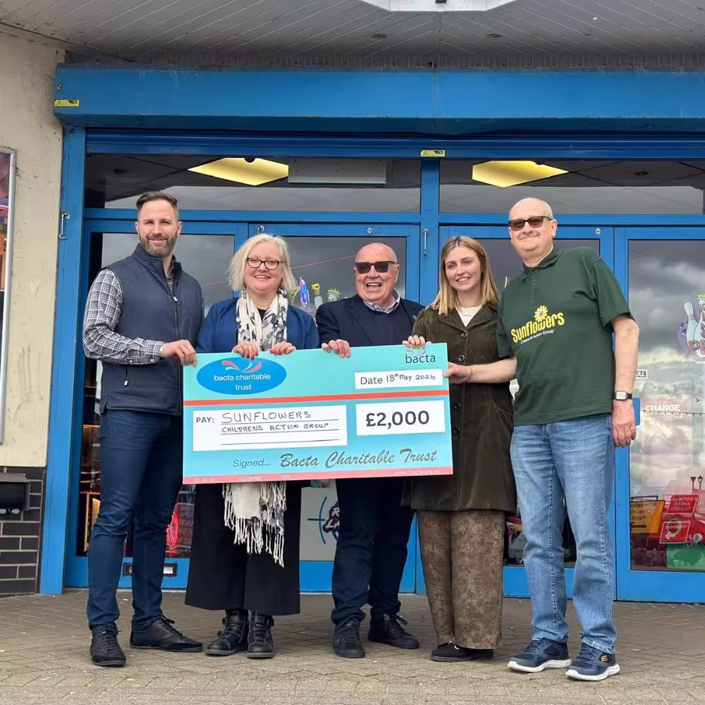 Bacta Charitable Trust hand over large cheque, donate £2000 to Sunflowers
