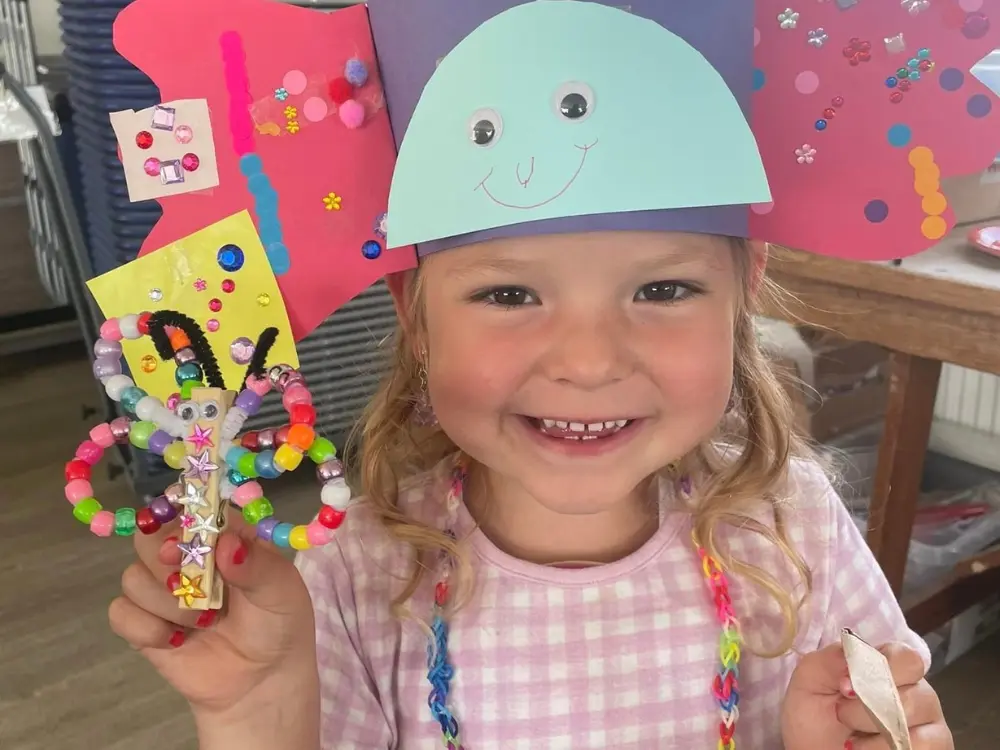 Sunflowers child Hattie shows of what she has created on a Craft Day