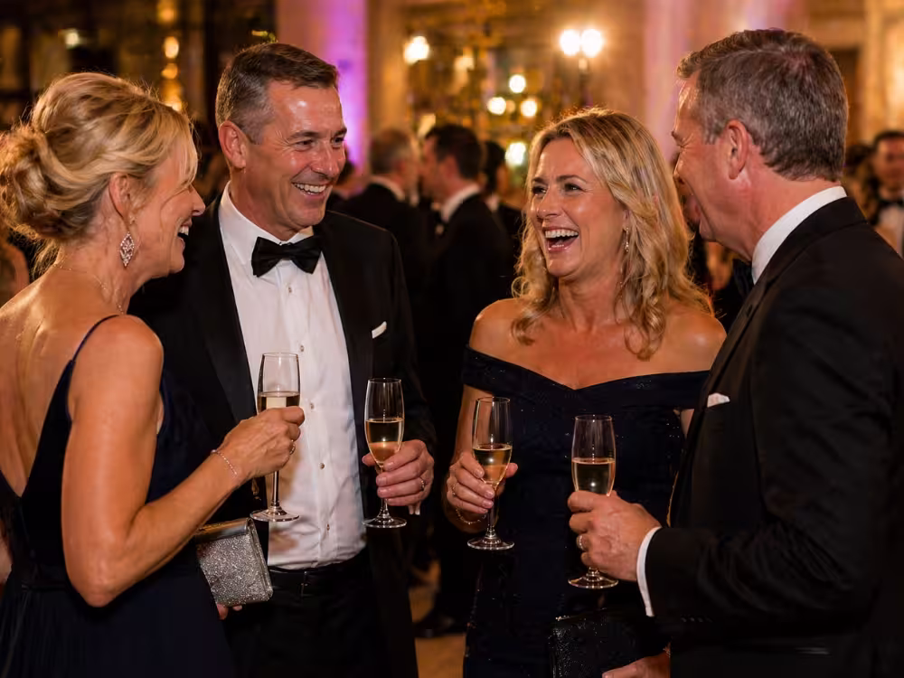 Guests in black tie enjoying champagne at the Sunflowers Charity Ball