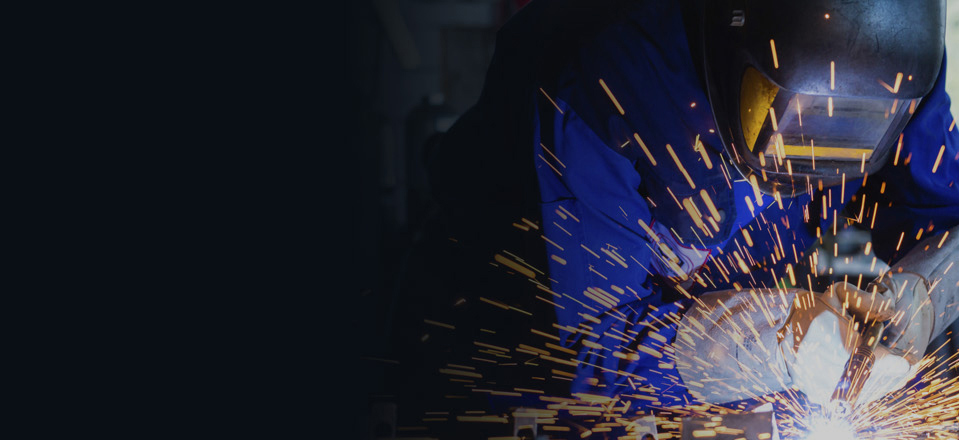 Worker operating a welding machine