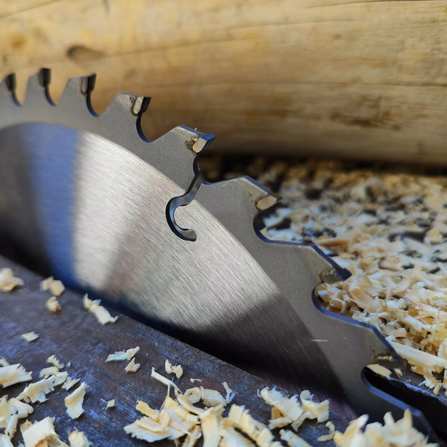 A table saw surrounded by sawdust.