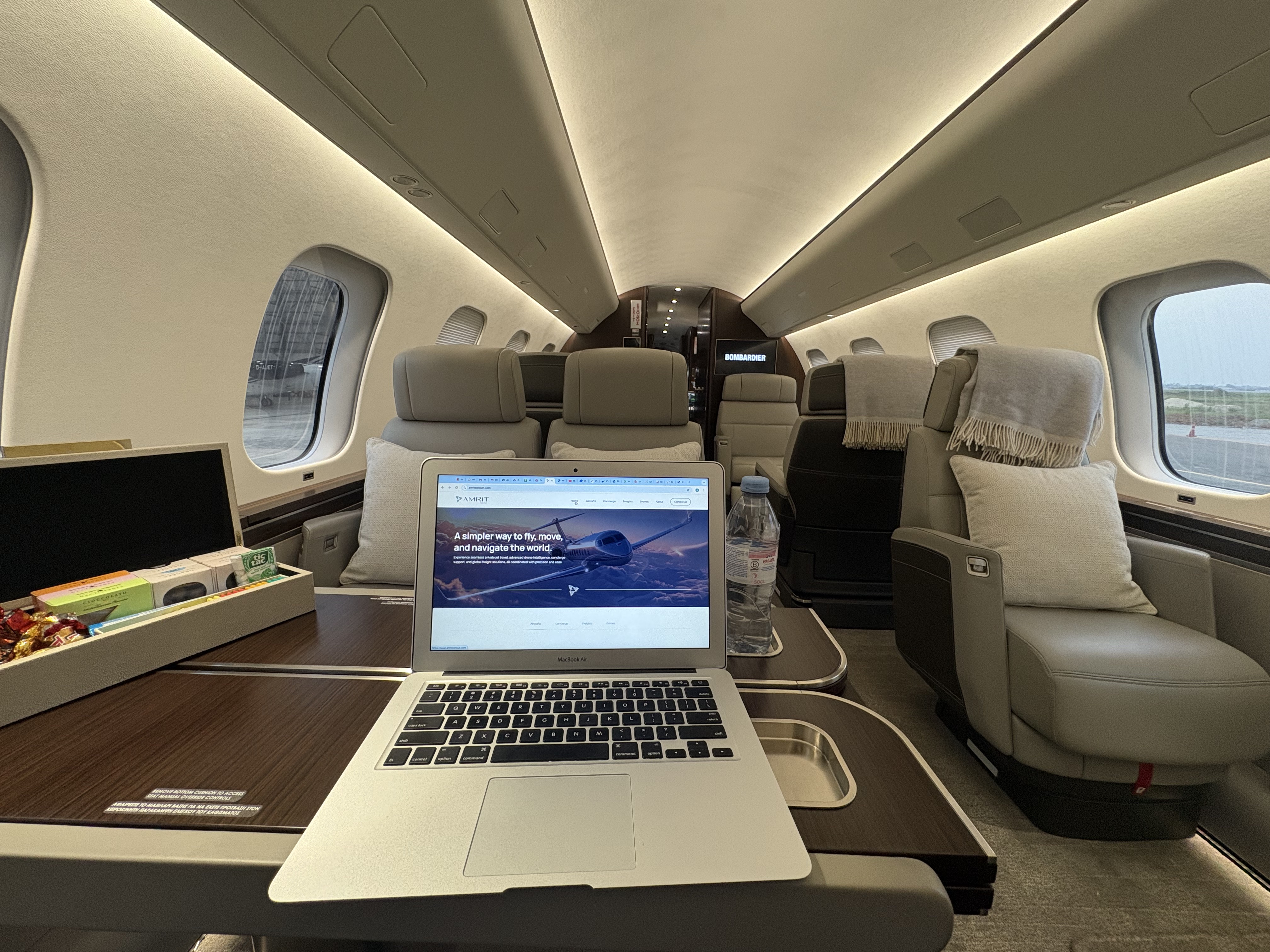 Luxury private jet seat with tray table set for a mea