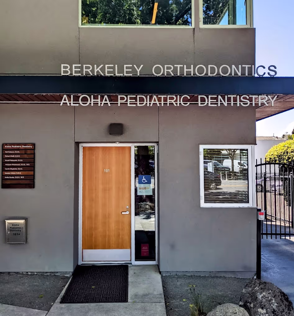 The entrance to a dental office with a wooden door.