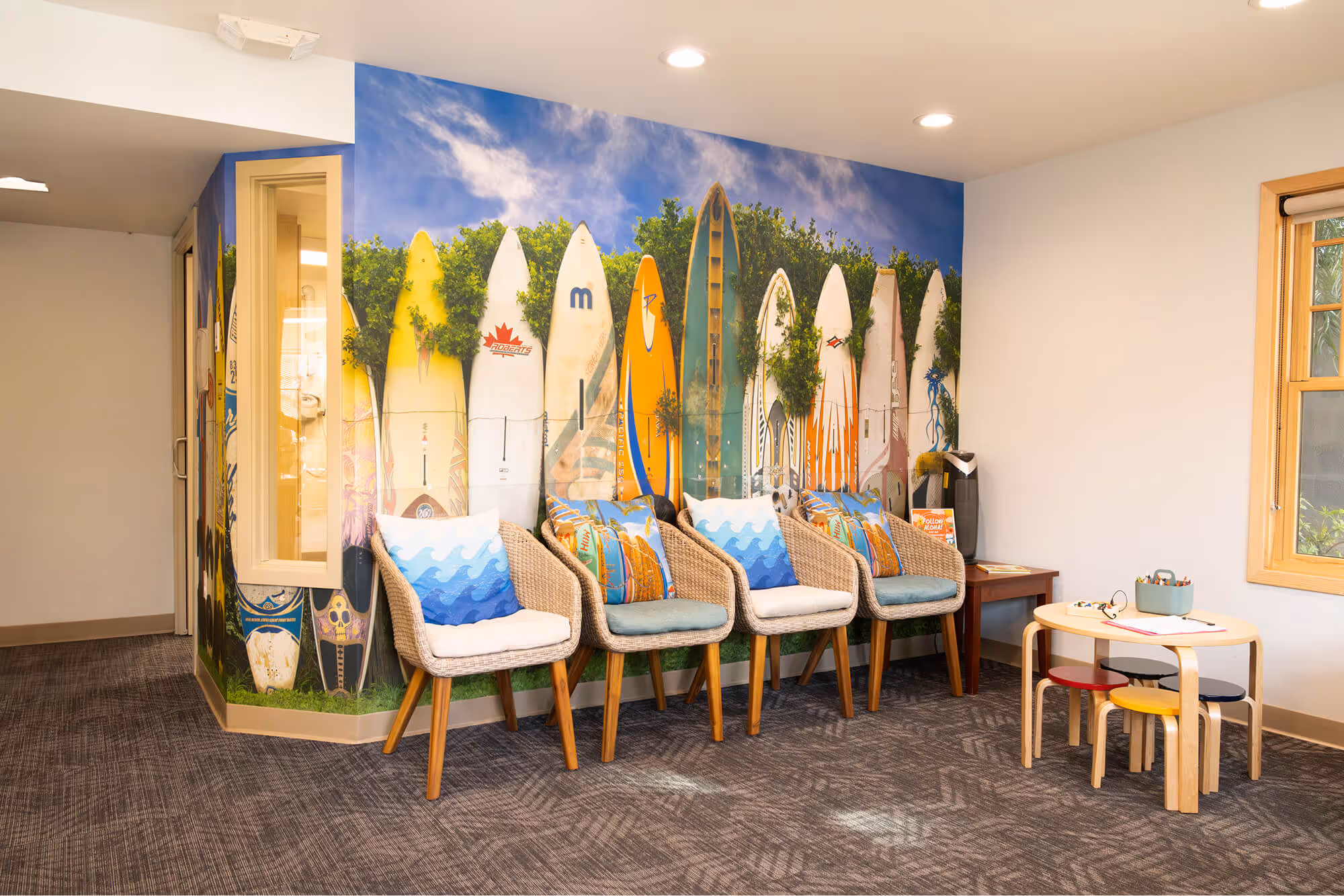 A room with a bunch of surfboards painted on the wall.