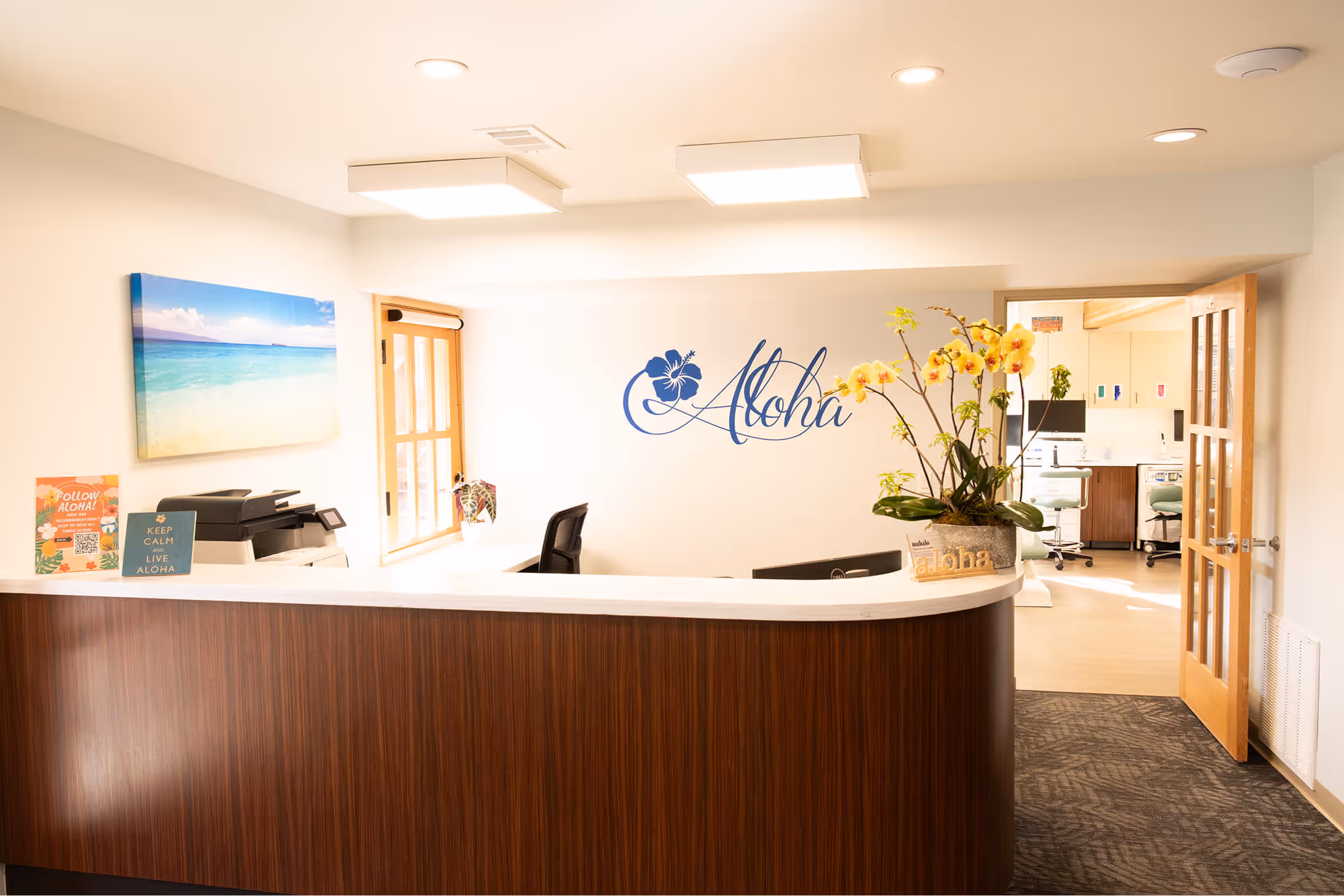 A reception desk with flowers in a vase.