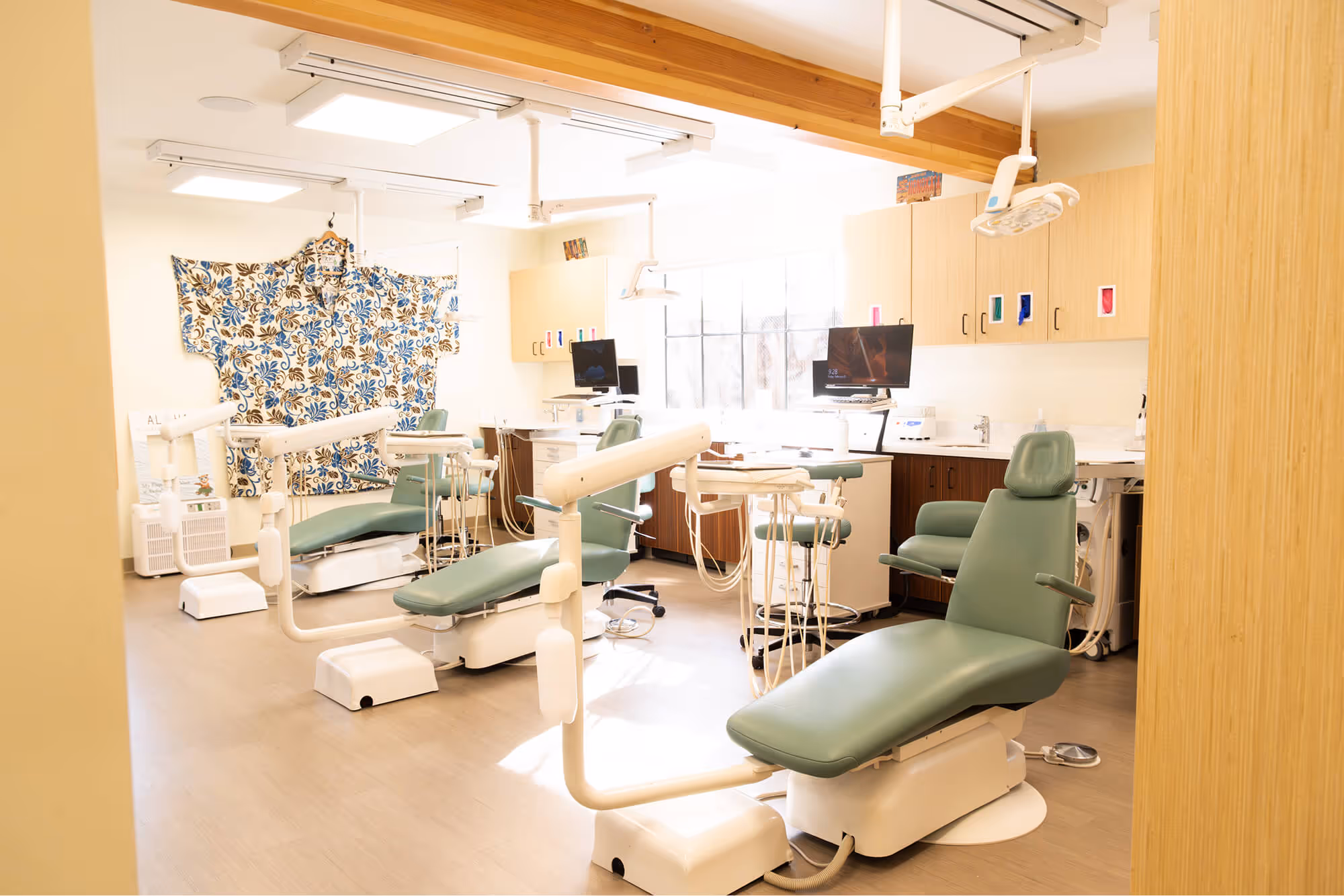 A dentist's office with chairs and lights.