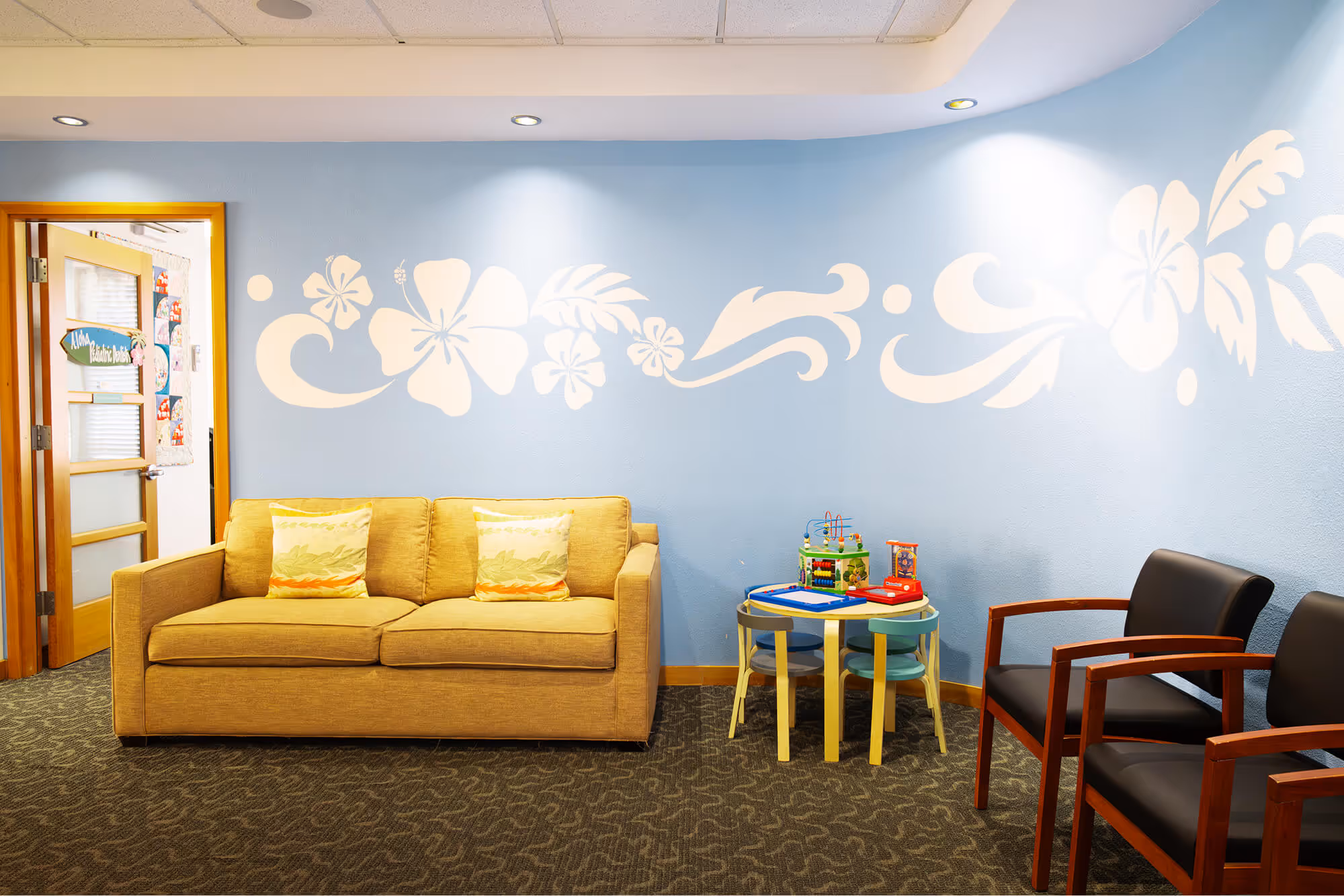 A living room filled with furniture and a blue wall.
