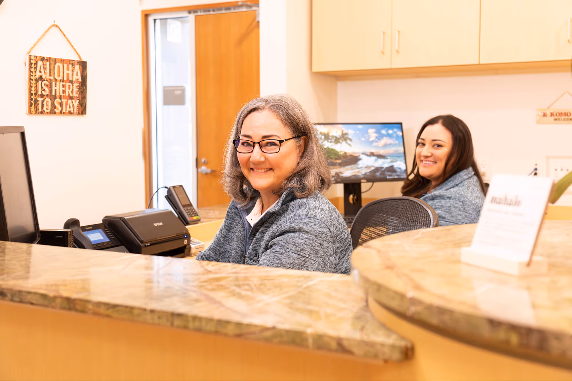 A couple of women sitting at a counter.