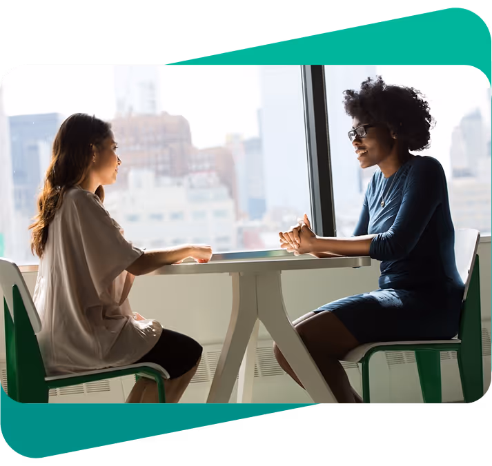 Conversation between two people around a table
