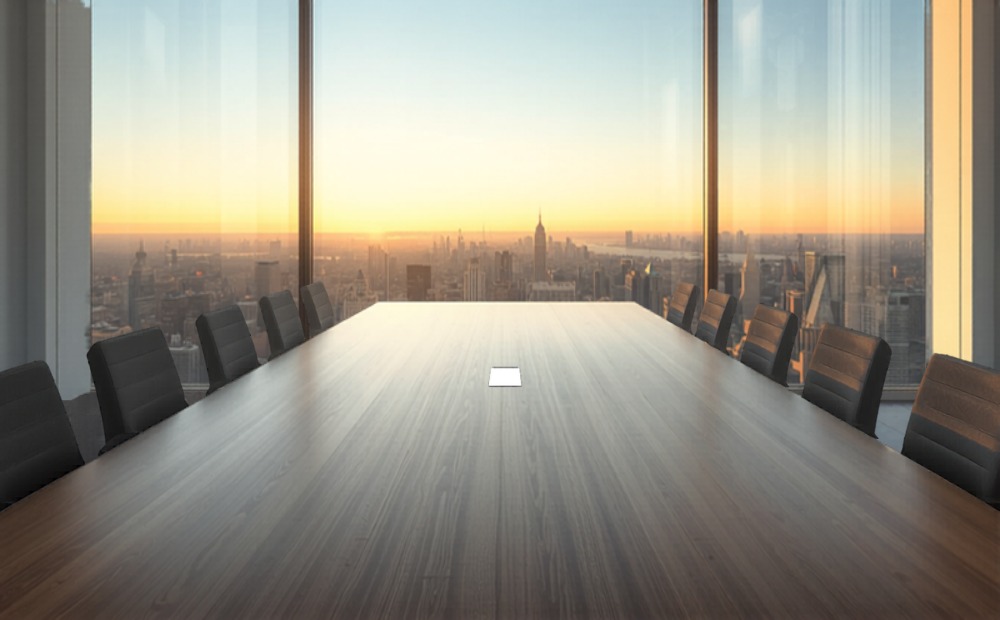 Modern boardroom with golden hour light through panoramic windows