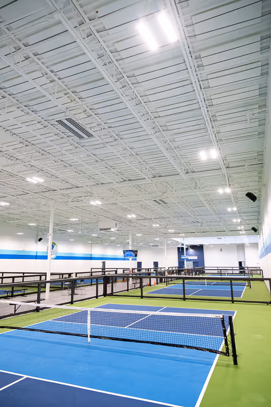 A well-lit, 7-court indoor pickleball facility in Jacksonville, Florida.