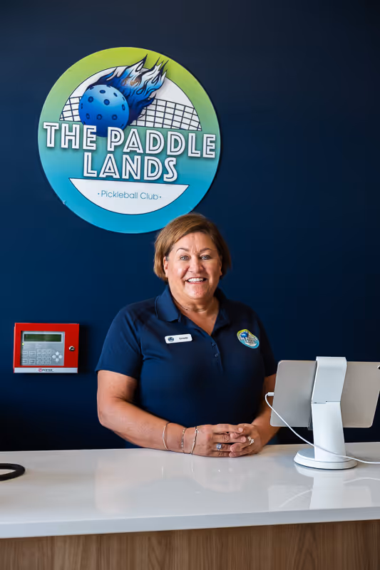 An employee at The Paddle Lands smiling.