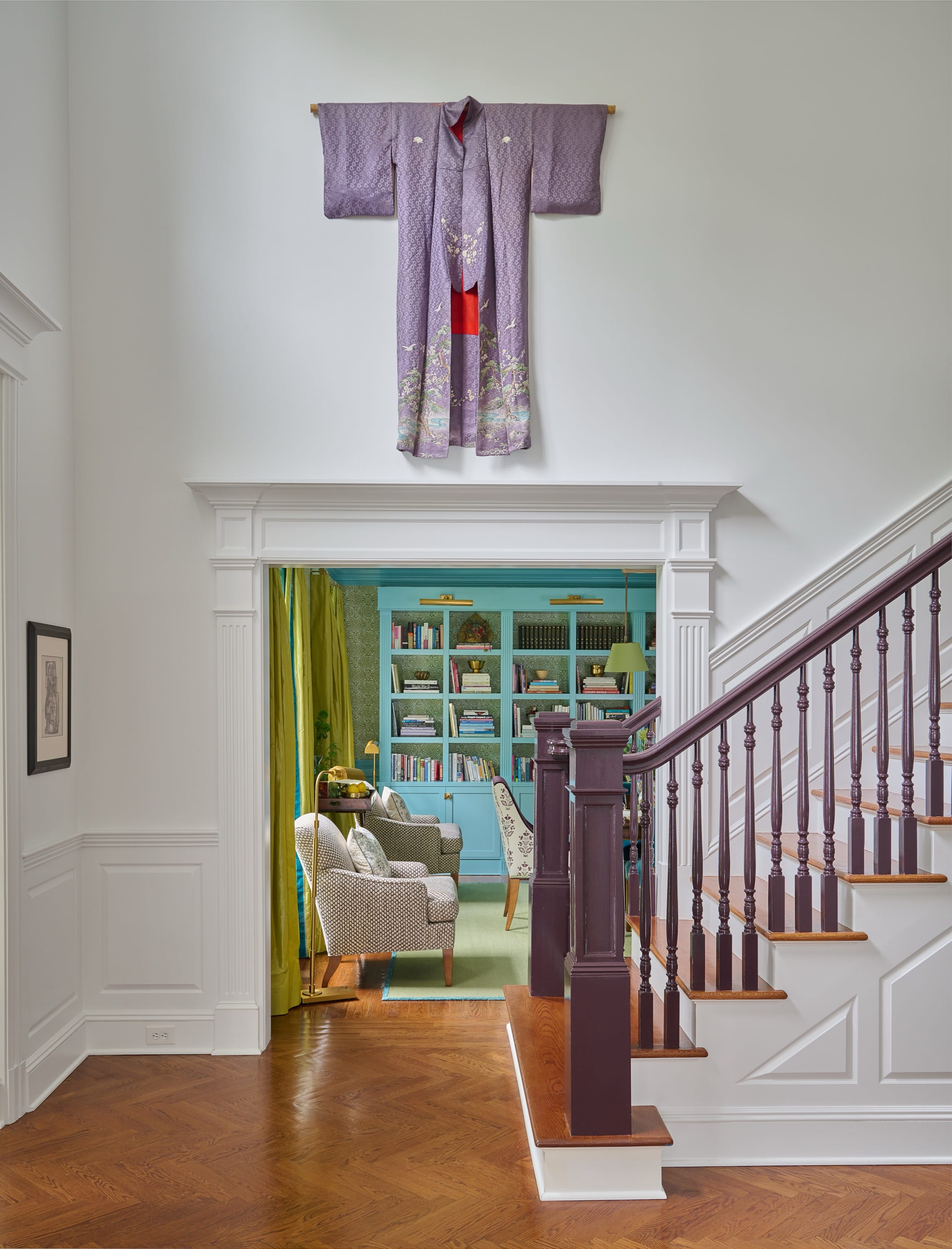 Foyer with large art and staircase designed by Brooke Crew Interiors.