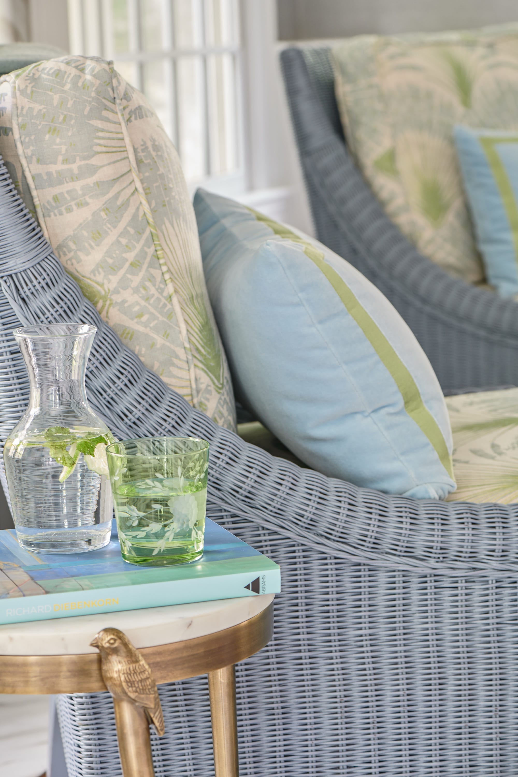 Close-up of sofa with pastel pillows and tray.