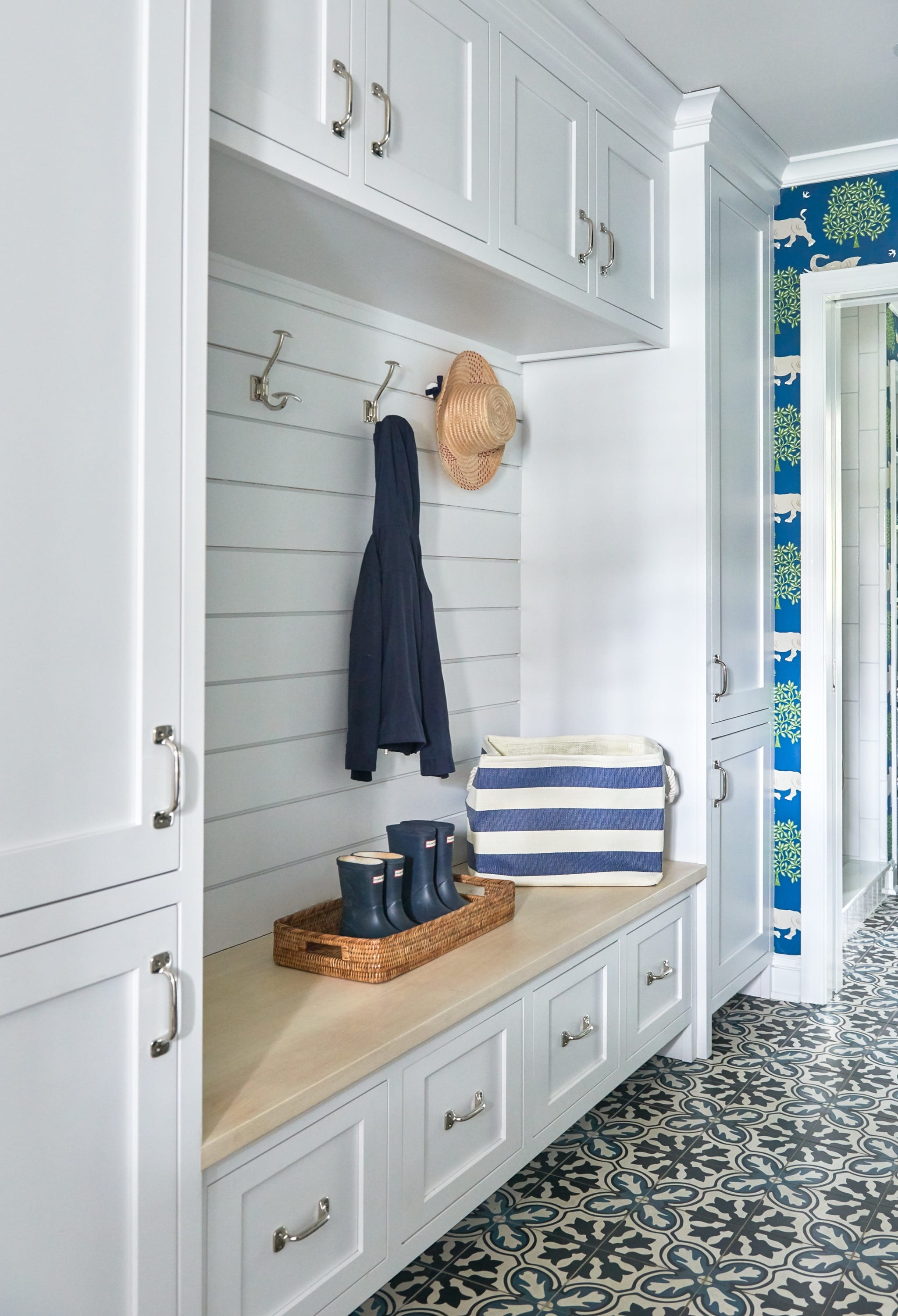 Mudroom with bench, hooks, and storage.
