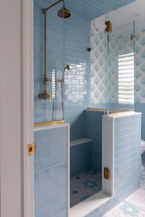 Bathroom with blue tile and double sinks.