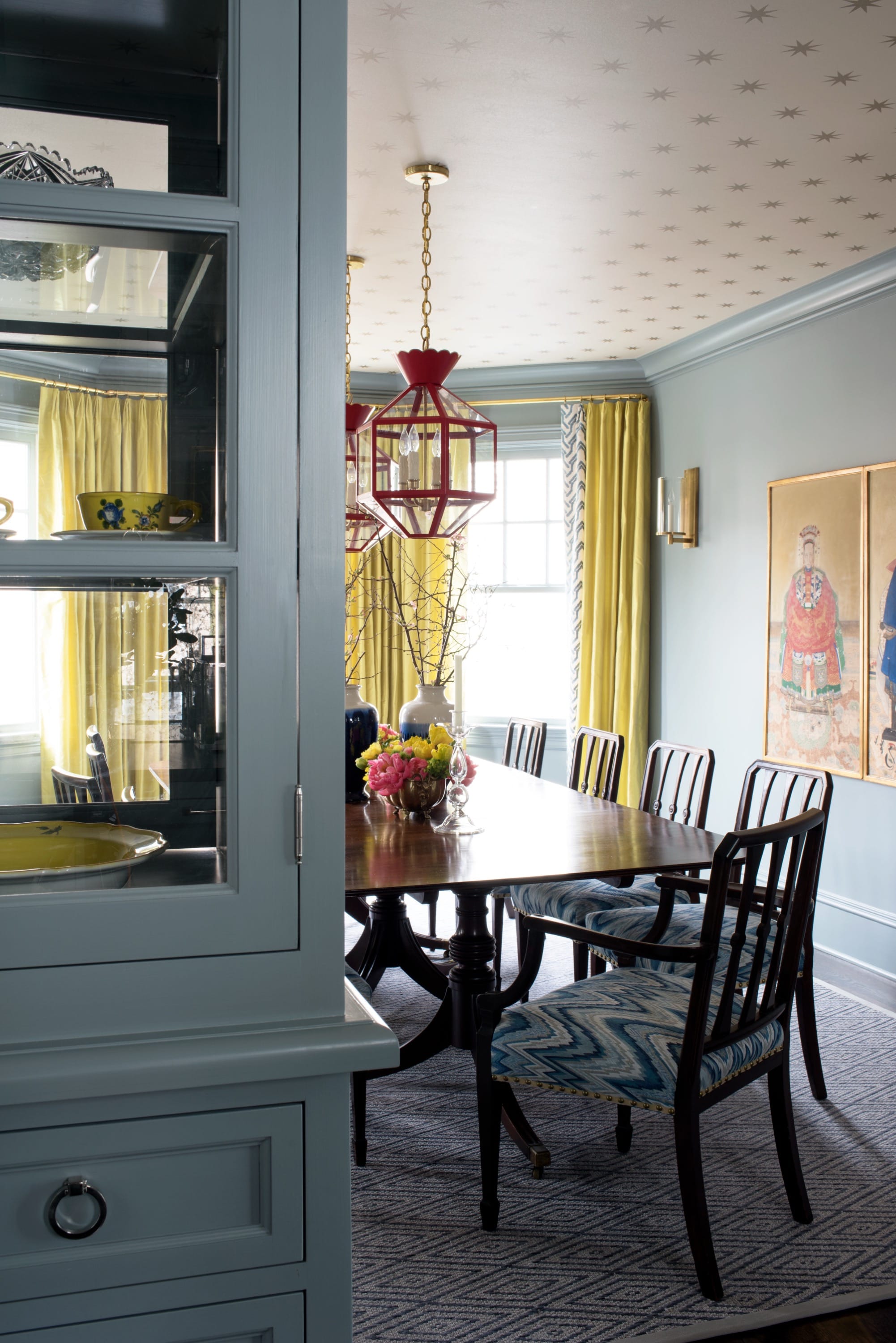 Dining room with dark table and pendant light.