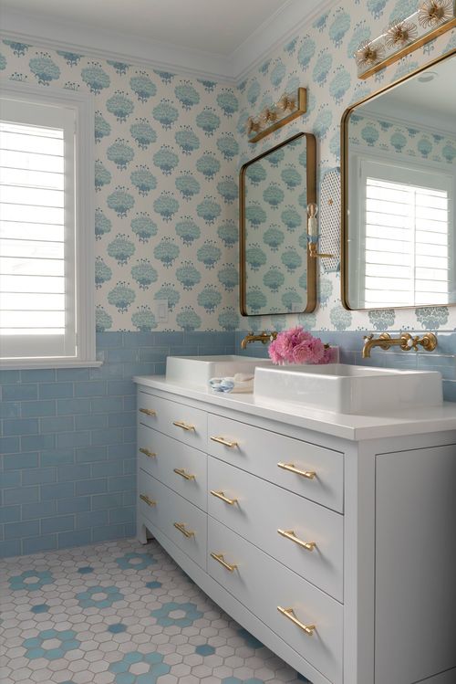 Bathroom with white vanity and blue walls.