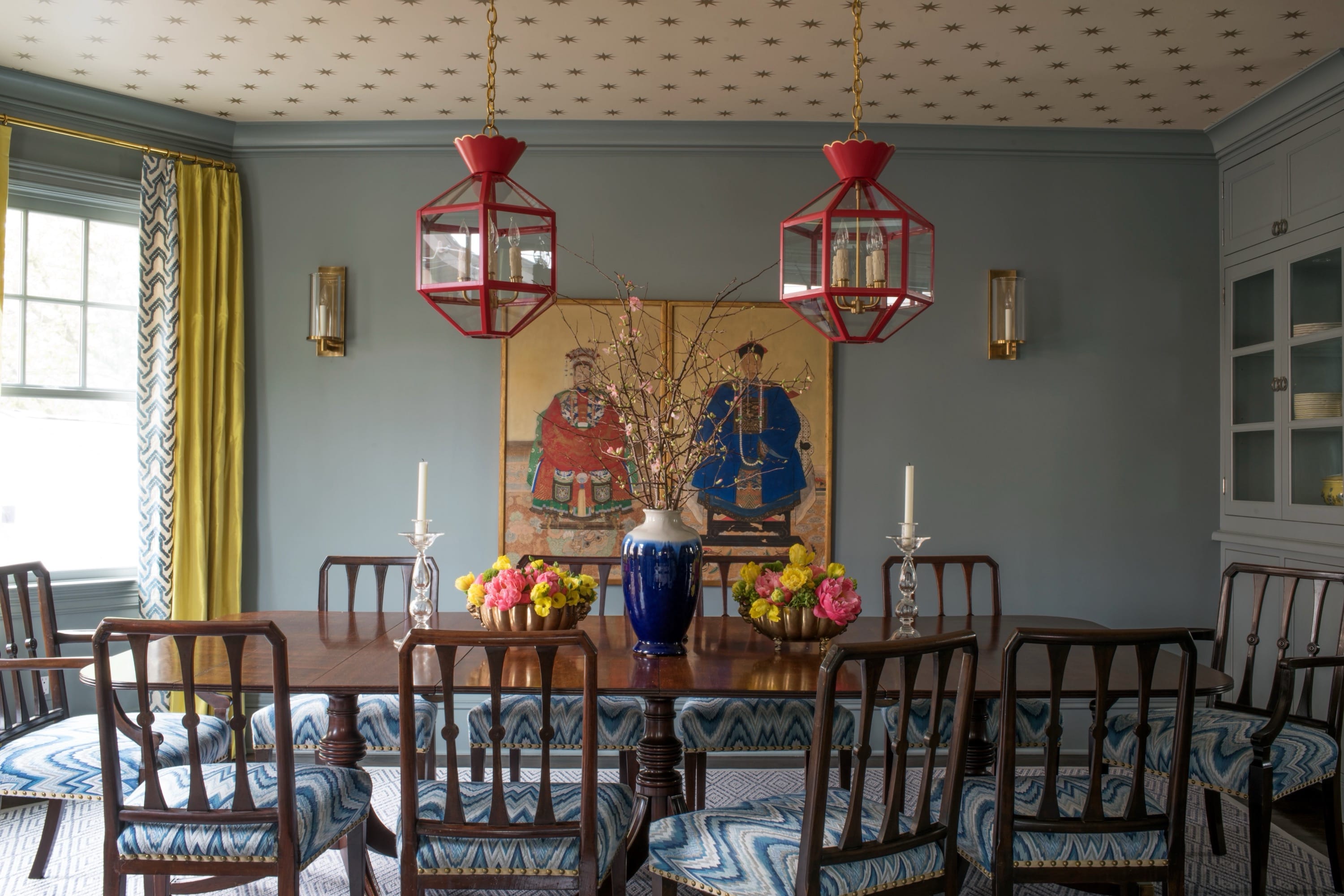 Dining room with long table and red lanterns.