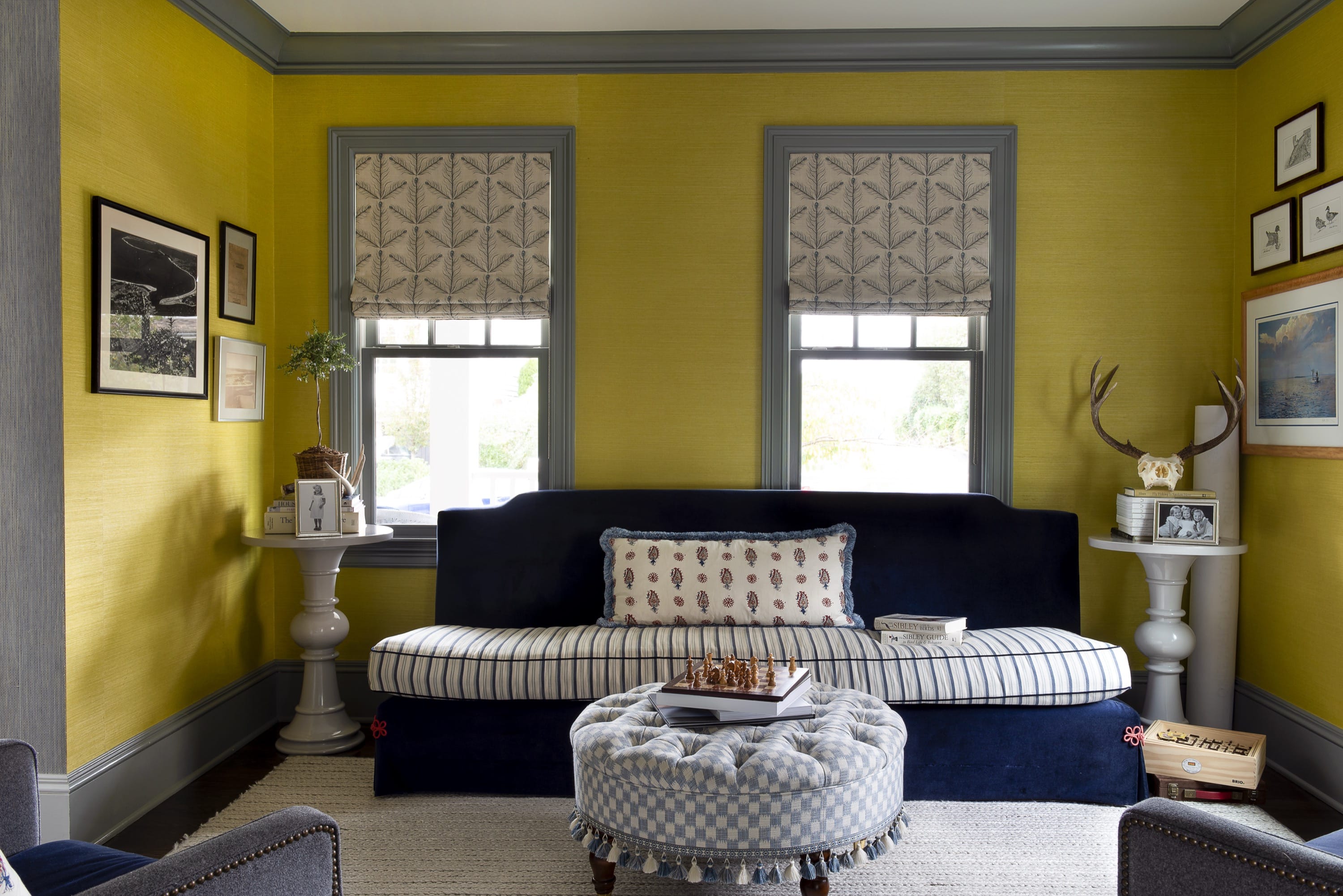 Living room with yellow walls and navy sofa.