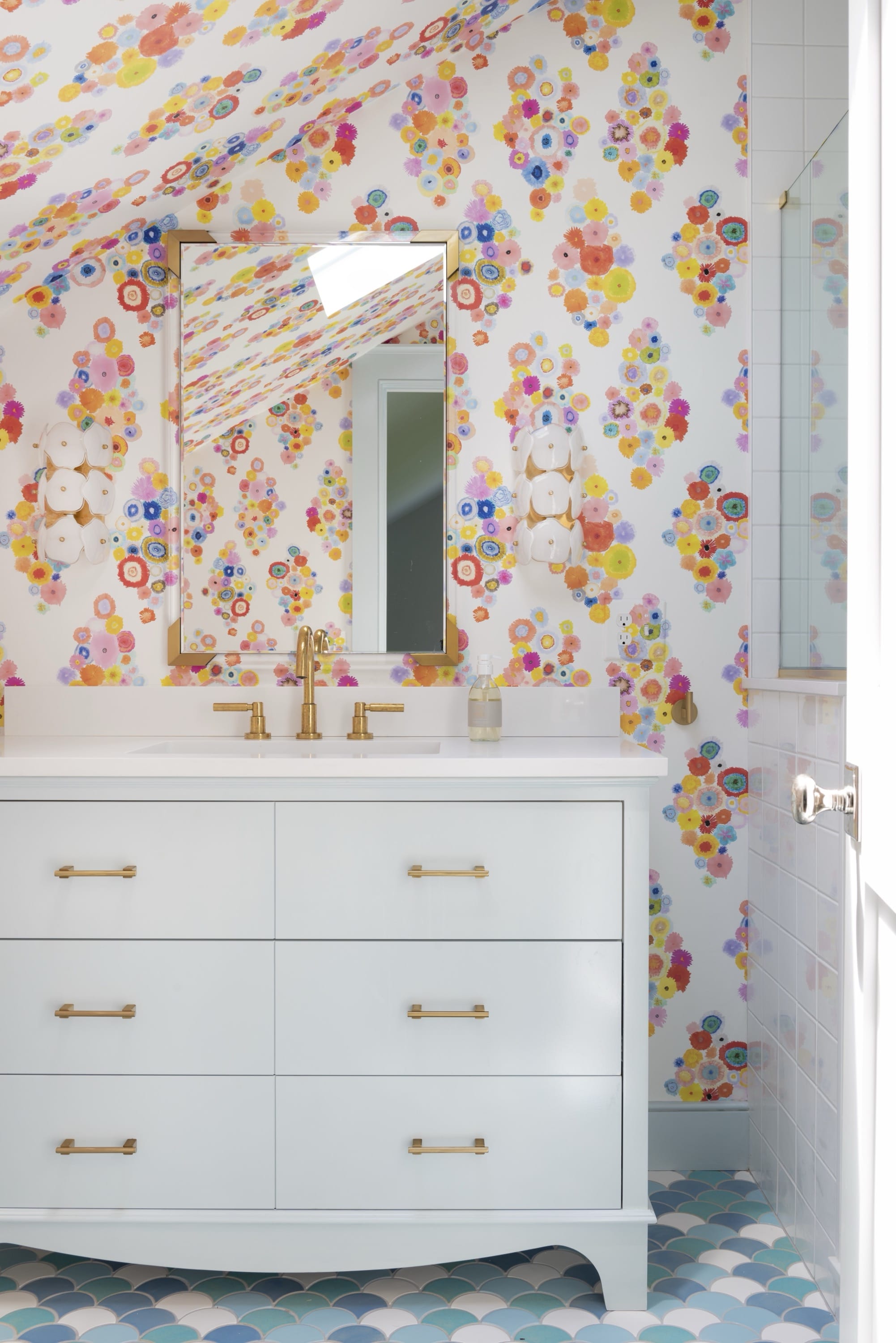 Girl’s bathroom with colorful floral wallpaper.