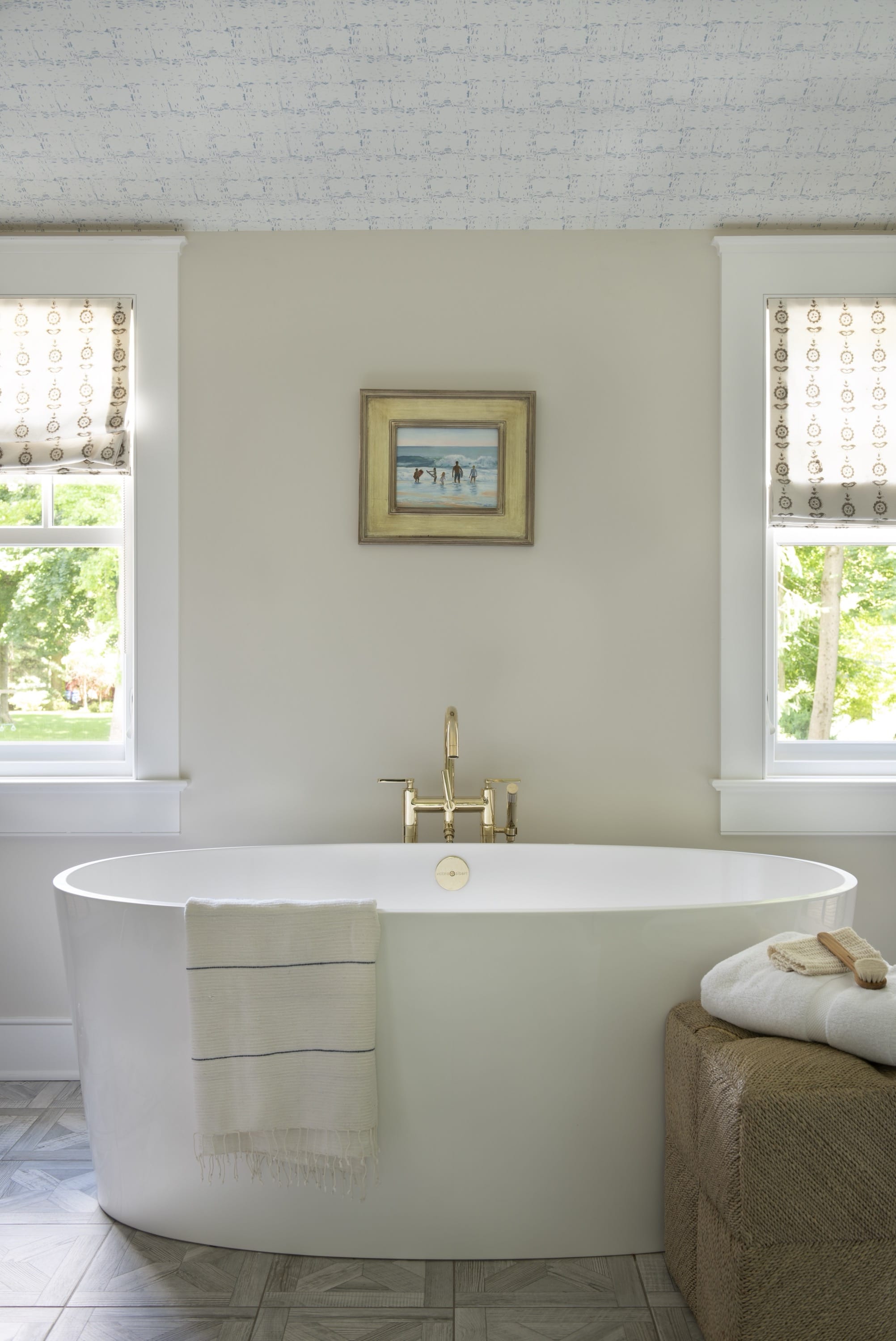 Bathroom with freestanding tub and artwork.