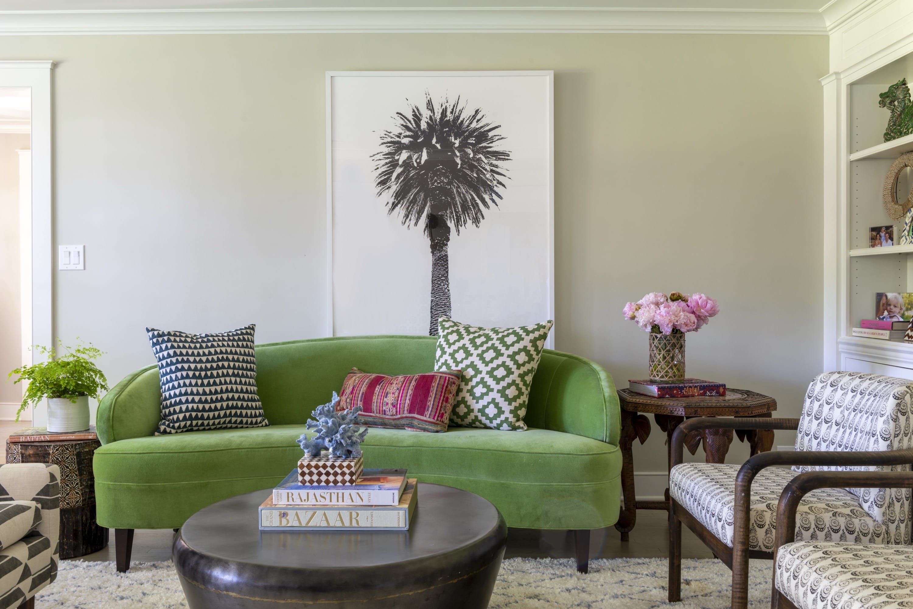 Living room with green sofa and round coffee table.